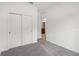 The bedroom features large closet doors, neutral paint, and soft gray carpeting at 1323 Wood Line Dr, Deland, FL 32720