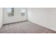 Neutral bedroom with carpeted floors, white walls, and two windows allowing for ample natural light at 1323 Wood Line Dr, Deland, FL 32720