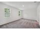 The room features large windows providing light, neutral walls, and plush gray carpeting at 1323 Wood Line Dr, Deland, FL 32720