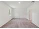 Bright bedroom featuring neutral walls, a window for natural light, and soft gray carpeting at 1323 Wood Line Dr, Deland, FL 32720