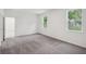 Spacious bedroom with neutral walls, two windows for natural light, and plush carpeting at 1323 Wood Line Dr, Deland, FL 32720