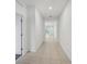 Hallway leading to multiple rooms, showcasing tile floors and bright, neutral walls at 1323 Wood Line Dr, Deland, FL 32720