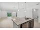 Open-concept kitchen flows into the living area, featuring granite countertops and a stainless steel dishwasher at 1323 Wood Line Dr, Deland, FL 32720