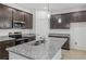 Modern kitchen features stainless steel appliances, granite countertops, and dark wood cabinetry at 1323 Wood Line Dr, Deland, FL 32720