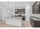 Bright kitchen showcases a large island, stainless appliances, dark cabinets, and tile flooring at 1323 Wood Line Dr, Deland, FL 32720