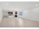 Open floor plan with neutral tile flooring showcasing the kitchen and living area at 1323 Wood Line Dr, Deland, FL 32720