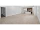 Bright, open-concept living area with neutral tile flooring and a view into the kitchen at 1323 Wood Line Dr, Deland, FL 32720