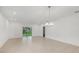 Large living room with neutral tile and sliding doors to a private outdoor space at 1323 Wood Line Dr, Deland, FL 32720
