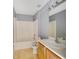 This bathroom has a shower over tub and a vanity with a single sink at 1406 Kissimmee Ct, Kissimmee, FL 34759