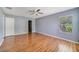 Spacious bedroom featuring hardwood floors, ample natural light, and a view of the en-suite bathroom at 1406 Kissimmee Ct, Kissimmee, FL 34759