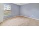 This cozy bedroom has plush carpeting and natural light streaming in from a large window at 1406 Kissimmee Ct, Kissimmee, FL 34759