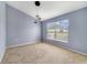 Bright bedroom with a large window and modern lighting fixture at 1406 Kissimmee Ct, Kissimmee, FL 34759