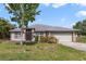 Charming single-story home with a well-maintained lawn and attached two-car garage at 1406 Kissimmee Ct, Kissimmee, FL 34759