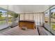 Relax in the screened in porch featuring a hot tub and wooden benches at 1406 Kissimmee Ct, Kissimmee, FL 34759