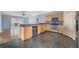 Well-equipped kitchen with stainless steel appliances, wooden cabinets, and a breakfast bar at 1406 Kissimmee Ct, Kissimmee, FL 34759