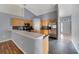 Open kitchen with stainless steel appliances, breakfast bar, and tile flooring at 1406 Kissimmee Ct, Kissimmee, FL 34759
