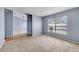 This living room has plush carpeting, a window, and neutral paint at 1406 Kissimmee Ct, Kissimmee, FL 34759