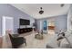 Cozy living area featuring comfortable seating, entertainment center, and access to the outdoor hot tub at 1406 Kissimmee Ct, Kissimmee, FL 34759