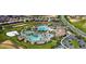 Aerial view of the community pool with chairs, shade, and a parking lot nearby at 1452 Moon Valley Dr, Davenport, FL 33896
