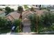 Aerial view of a home with a tile roof, two-car garage, and brick-paved driveway at 1452 Moon Valley Dr, Davenport, FL 33896