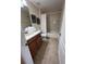 This bathroom features a bathtub, a shower curtain and a single sink vanity with towels at 1452 Moon Valley Dr, Davenport, FL 33896