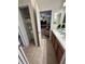 This bathroom has dual sinks, wooden cabinets and a linen closet with an open door at 1452 Moon Valley Dr, Davenport, FL 33896