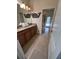 Bright bathroom boasts granite counters, dual sinks, and a walk-in shower at 1452 Moon Valley Dr, Davenport, FL 33896