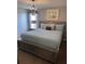 Comfortable bedroom with a king bed, closet, and chandelier lighting at 1452 Moon Valley Dr, Davenport, FL 33896
