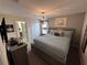 Comfortable bedroom with a king size bed and chandelier lighting fixture at 1452 Moon Valley Dr, Davenport, FL 33896