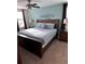 The bedroom is decorated with a bicycle wall art and has a large wooden bed at 1452 Moon Valley Dr, Davenport, FL 33896