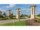 Entrance to Champions Gate neighborhood with manicured landscaping at 1452 Moon Valley Dr, Davenport, FL 33896