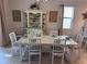 The bright and inviting dining room features a glass-top table set for a meal and decorative built-in shelving at 1452 Moon Valley Dr, Davenport, FL 33896