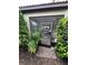 Screened in back entrance to house featuring stone pavers surrounded by greenery at 1452 Moon Valley Dr, Davenport, FL 33896