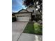 Attractive stucco exterior with a tile roof, well-maintained landscaping, and a two-car garage at 1452 Moon Valley Dr, Davenport, FL 33896