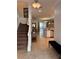 Inviting home foyer with a staircase, leading to the living room and kitchen at 1452 Moon Valley Dr, Davenport, FL 33896