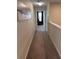 This hallway leads to carpeted rooms and a sunny window at 1452 Moon Valley Dr, Davenport, FL 33896