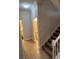 Hallway features carpeted stairs with white railing, leading to a bathroom and laundry room at 1452 Moon Valley Dr, Davenport, FL 33896
