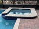 A relaxing hot tub with brick pavers is the perfect way to enjoy your backyard at 1452 Moon Valley Dr, Davenport, FL 33896