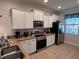 Modern kitchen with stainless steel appliances and granite countertops at 1452 Moon Valley Dr, Davenport, FL 33896