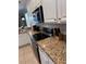 Well-equipped kitchen with stainless steel appliances and granite countertops provides a functional and stylish cooking space at 1452 Moon Valley Dr, Davenport, FL 33896