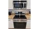 Stainless steel appliances and granite countertops at 1452 Moon Valley Dr, Davenport, FL 33896