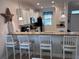 Kitchen bar with seating and granite countertops at 1452 Moon Valley Dr, Davenport, FL 33896