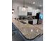 Kitchen bar with seating and granite countertops at 1452 Moon Valley Dr, Davenport, FL 33896