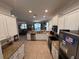 Bright and airy kitchen with white cabinets, stainless steel appliances, and granite countertops at 1452 Moon Valley Dr, Davenport, FL 33896