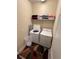 Convenient laundry room equipped with a washer, dryer, and storage shelves for added functionality at 1452 Moon Valley Dr, Davenport, FL 33896