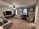 Cozy living room with plush seating, a ceiling fan and lots of natural light at 1452 Moon Valley Dr, Davenport, FL 33896