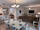 Open-concept floor plan showcases a dining area and living room with comfortable seating and modern decor at 1452 Moon Valley Dr, Davenport, FL 33896