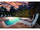 Enjoy this private screened-in pool with a hot tub and lounge chairs at 1452 Moon Valley Dr, Davenport, FL 33896