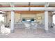 Exterior of a pool bar with an open view, tables, chairs, and wooden beams at 1452 Moon Valley Dr, Davenport, FL 33896