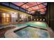 Outdoor pool and hot tub with covered seating area is perfect for entertaining and relaxing under the sunset at 1452 Moon Valley Dr, Davenport, FL 33896